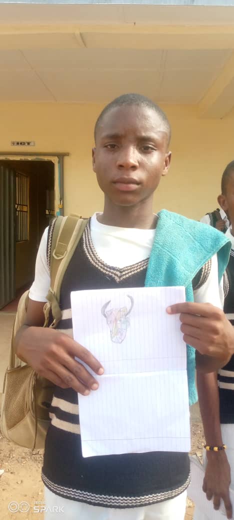 Student holding Picasso-inspired artwork — cropped to show artwork only